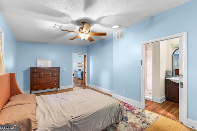 6567 Tahiti Way, Flowery Branch, GA 30542 - bedroom with wood finished floors and a ceiling fan