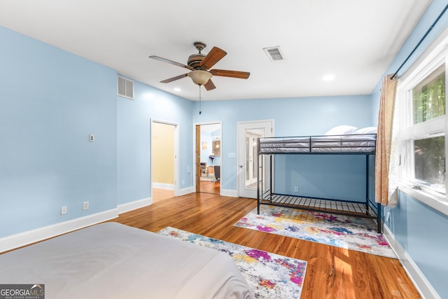 6567 Tahiti Way, Flowery Branch, GA 30542 - bedroom with wood finished floors, recessed lighting, and a ceiling fan