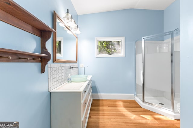 6567 Tahiti Way, Flowery Branch, GA 30542 - bathroom featuring vanity, wood finished floors, a stall shower, and lofted ceiling