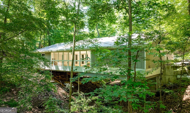 6567 Tahiti Way, Flowery Branch, GA 30542 - back of property featuring a sunroom