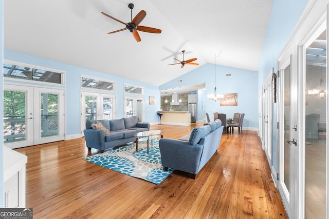 6567 Tahiti Way, Flowery Branch, GA 30542 - living area with french doors, ceiling fan, a chandelier, high vaulted ceiling, and light wood-style floors