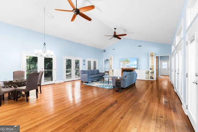 6567 Tahiti Way, Flowery Branch, GA 30542 - living room featuring french doors, high vaulted ceiling, ceiling fan, light wood-style floors, and healthy amount of natural light