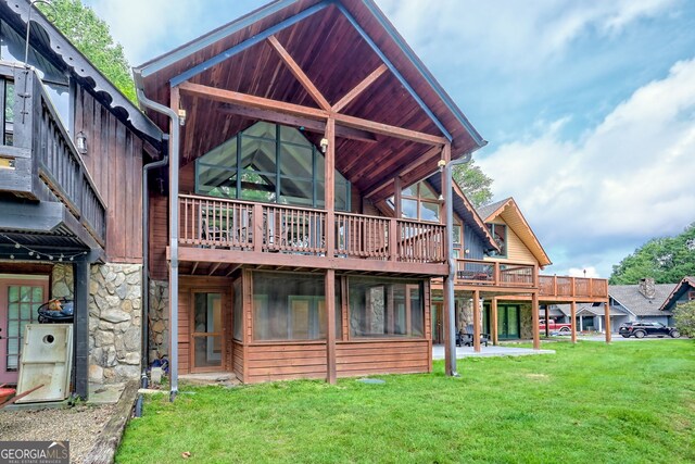 33 Berkshire Ln, Dillard, GA 30537 - back of property with stone siding, a lawn, and a deck