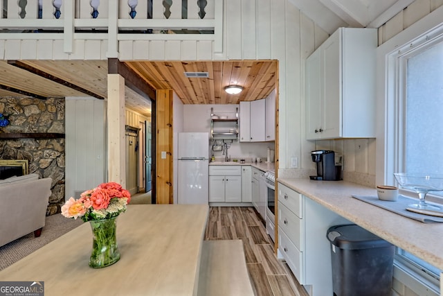33 Berkshire Ln, Dillard, GA 30537 - kitchen featuring white appliances, light countertops, white cabinets, and light wood-style floors