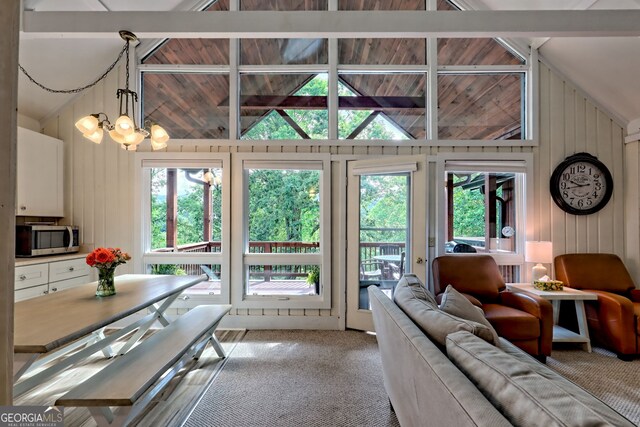 33 Berkshire Ln, Dillard, GA 30537 - living area with light colored carpet, wood walls, and a chandelier