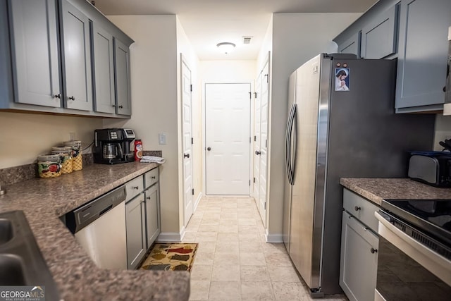 126 Savannah Way, Milner, GA 30257 - kitchen with appliances with stainless steel finishes and gray cabinets