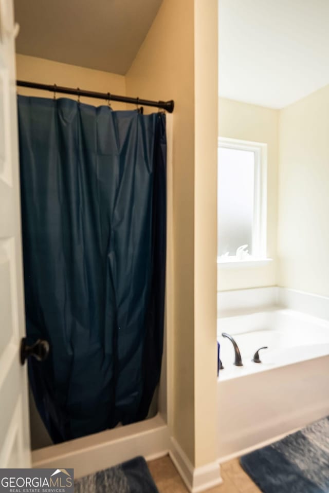 126 Savannah Way, Milner, GA 30257 - full bathroom with a shower stall, a bath, and tile patterned floors