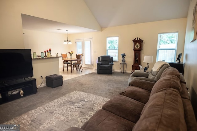 126 Savannah Way, Milner, GA 30257 - carpeted living room with a chandelier and vaulted ceiling