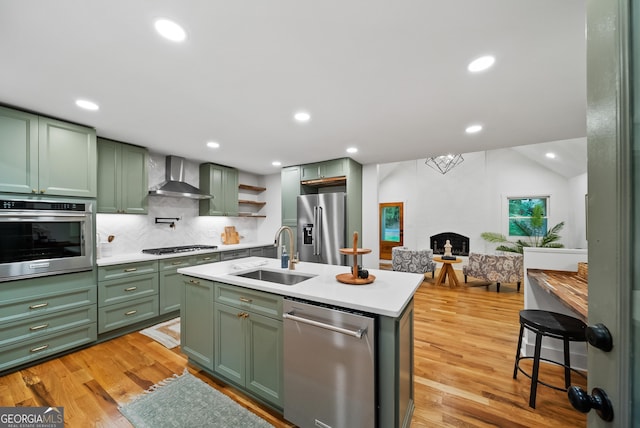 685 Pinecrest Dr, Athens, GA 30605 - kitchen featuring green cabinetry, appliances with stainless steel finishes, wall chimney exhaust hood, light countertops, and backsplash