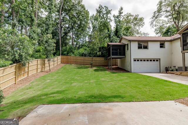 685 Pinecrest Dr, Athens, GA 30605 - view of yard featuring a sunroom, a garage, and concrete driveway