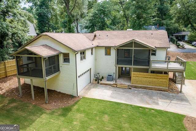685 Pinecrest Dr, Athens, GA 30605 - back of property with a sunroom, a shingled roof, driveway, and a wooden deck