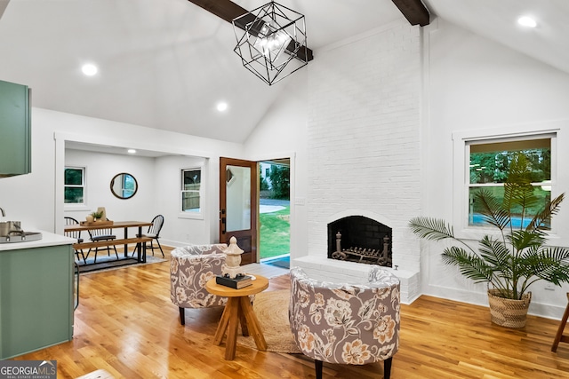 685 Pinecrest Dr, Athens, GA 30605 - living room with high vaulted ceiling, light wood finished floors, beamed ceiling, a chandelier, and a fireplace