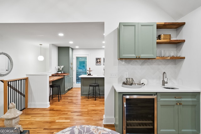 685 Pinecrest Dr, Athens, GA 30605 - indoor wet bar featuring beverage cooler, backsplash, light wood-style floors, and recessed lighting