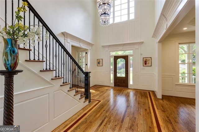930 Shepards Ct, Roswell, GA 30075 - entrance foyer featuring a decorative wall, a towering ceiling, wood finished floors, a chandelier, and plenty of natural light