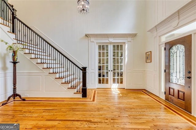 930 Shepards Ct, Roswell, GA 30075 - entryway with a high ceiling, wood finished floors, a decorative wall, french doors, and stairway