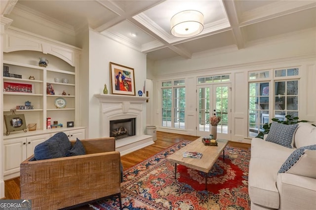 930 Shepards Ct, Roswell, GA 30075 - living room featuring wood finished floors, a fireplace with raised hearth, coffered ceiling, beamed ceiling, and crown molding