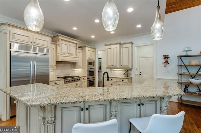 930 Shepards Ct, Roswell, GA 30075 - kitchen featuring cream cabinets, tasteful backsplash, wood finished floors, a breakfast bar area, and crown molding