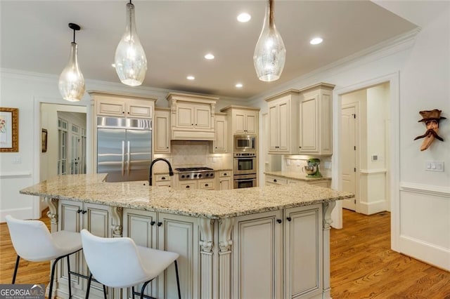 930 Shepards Ct, Roswell, GA 30075 - kitchen with built in appliances, cream cabinetry, tasteful backsplash, crown molding, and a kitchen breakfast bar
