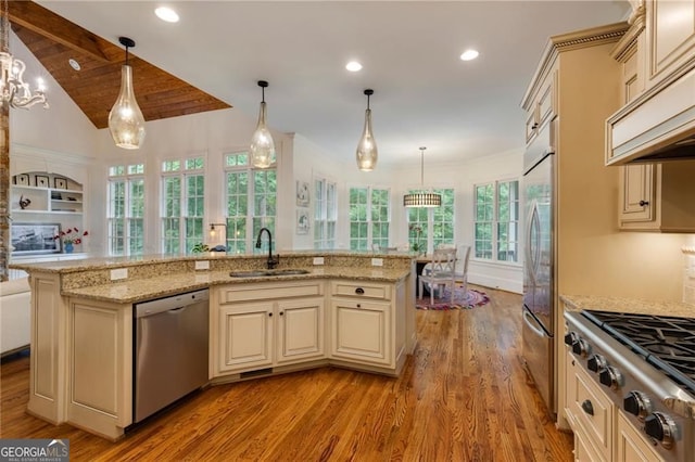 930 Shepards Ct, Roswell, GA 30075 - kitchen featuring cream cabinets, appliances with stainless steel finishes, light wood-style floors, open floor plan, and light stone countertops