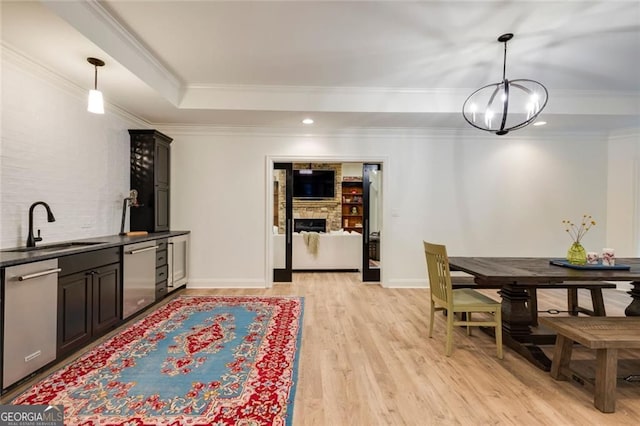 930 Shepards Ct, Roswell, GA 30075 - dining area with a chandelier, crown molding, light wood-type flooring, a tray ceiling, and a fireplace