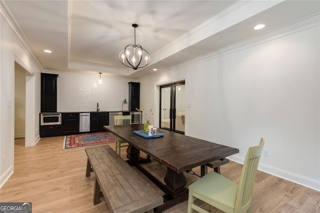 930 Shepards Ct, Roswell, GA 30075 - dining space with light wood-style floors, a tray ceiling, crown molding, french doors, and a chandelier