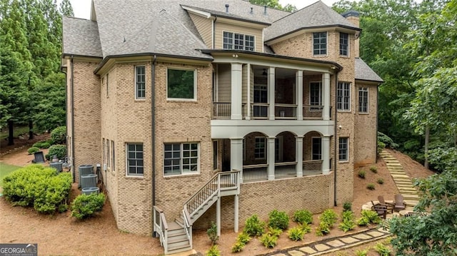 930 Shepards Ct, Roswell, GA 30075 - view of front of home featuring stairs, a balcony, brick siding, and roof with shingles