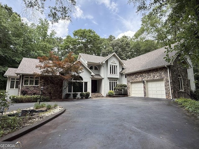 1906 1st St, Lanett, AL 36863 - view of front of property featuring stone siding, driveway, an attached garage, and a shingled roof
