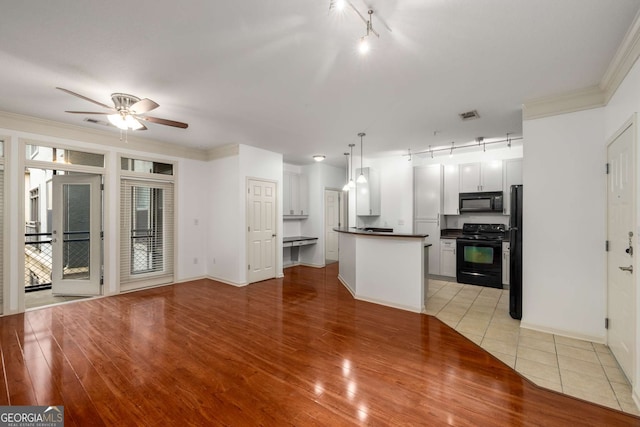 400 17th St NW Unit 2308, Atlanta, GA 30363 - kitchen featuring black appliances, rail lighting, dark countertops, a ceiling fan, and light wood-style floors