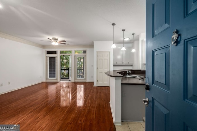 400 17th St NW Unit 2308, Atlanta, GA 30363 - kitchen with dark countertops, ceiling fan, blue cabinetry, wood finished floors, and open floor plan