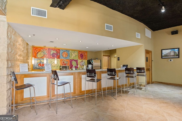 400 17th St NW Unit 2308, Atlanta, GA 30363 - kitchen with a high ceiling, freestanding refrigerator, a peninsula, rail lighting, and tile patterned flooring