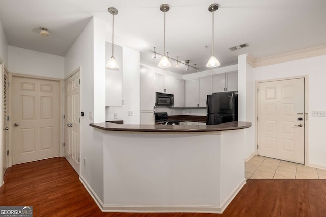 400 17th St NW Unit 2308, Atlanta, GA 30363 - kitchen featuring black appliances, dark countertops, and light wood-style flooring