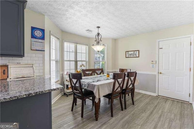 3589 Garden Manor Dr, Loganville, GA 30052 - dining area featuring light wood-style floors and a textured ceiling