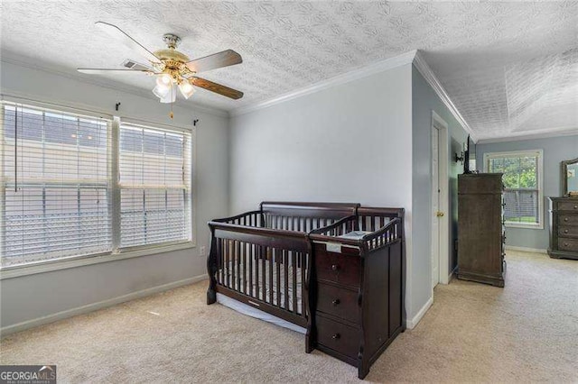 3589 Garden Manor Dr, Loganville, GA 30052 - bedroom with carpet flooring, a nursery area, a textured ceiling, a ceiling fan, and crown molding