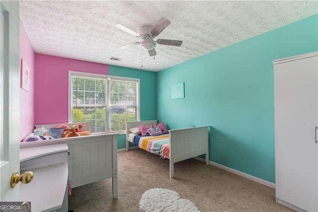 3589 Garden Manor Dr, Loganville, GA 30052 - bedroom with a textured ceiling, carpet floors, and ceiling fan