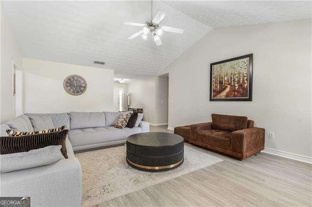 3589 Garden Manor Dr, Loganville, GA 30052 - living area with wood finished floors, lofted ceiling, a ceiling fan, and a textured ceiling