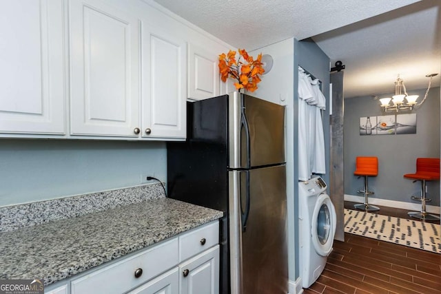 375 Ralph Mcgill Blvd NE Unit 1701, Atlanta, GA 30312 - kitchen featuring washer / dryer, freestanding refrigerator, white cabinets, dark wood-style flooring, and a chandelier