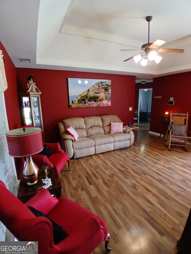 606 Haverhill Cir, Warner Robins, GA 31088 - living room featuring ceiling fan, a tray ceiling, and wood finished floors