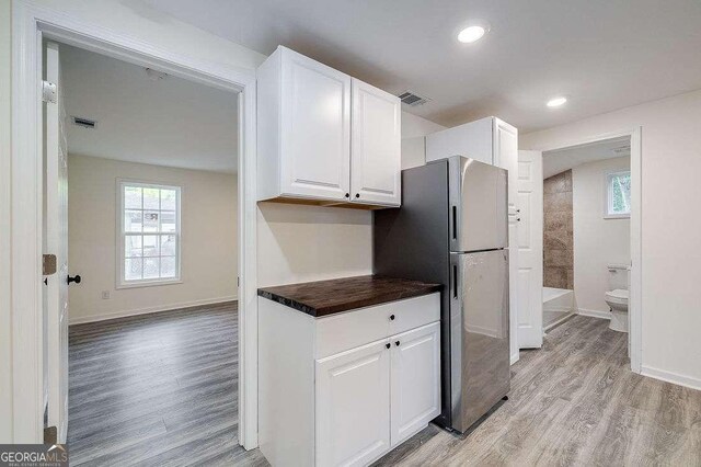 5215 Cordell St, Savannah, GA 31405 - kitchen featuring freestanding refrigerator, light wood-type flooring, white cabinets, and recessed lighting