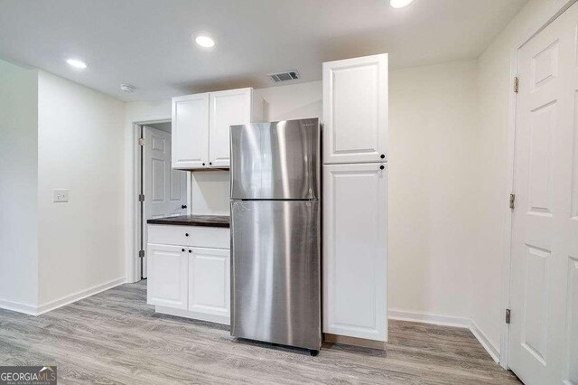 5215 Cordell St, Savannah, GA 31405 - kitchen featuring freestanding refrigerator, white cabinets, light wood-style flooring, and recessed lighting