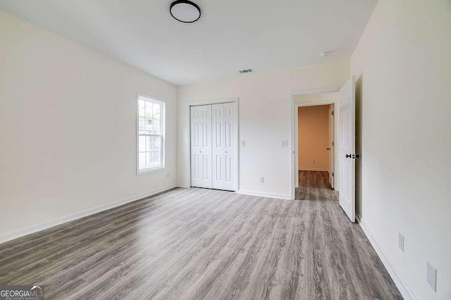 5215 Cordell St, Savannah, GA 31405 - unfurnished bedroom with wood finished floors and a closet