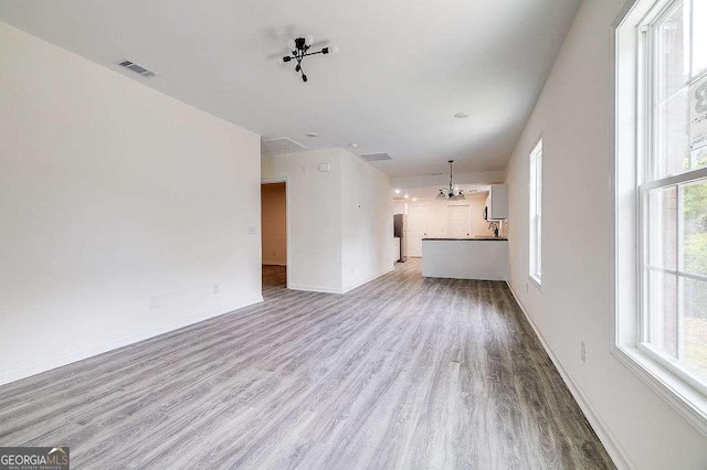 5215 Cordell St, Savannah, GA 31405 - unfurnished living room with wood finished floors and a chandelier