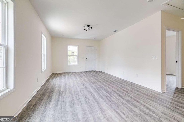 5215 Cordell St, Savannah, GA 31405 - unfurnished living room featuring wood finished floors and attic access