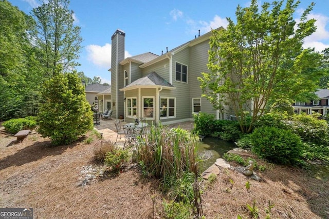 295 River Laurel Way, Woodstock, GA 30188 - back of house with a chimney and a patio