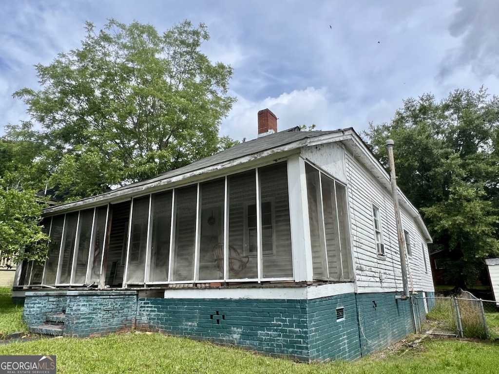811 Greenville St, Lagrange, GA 30241 - view of property exterior featuring a sunroom and a chimney