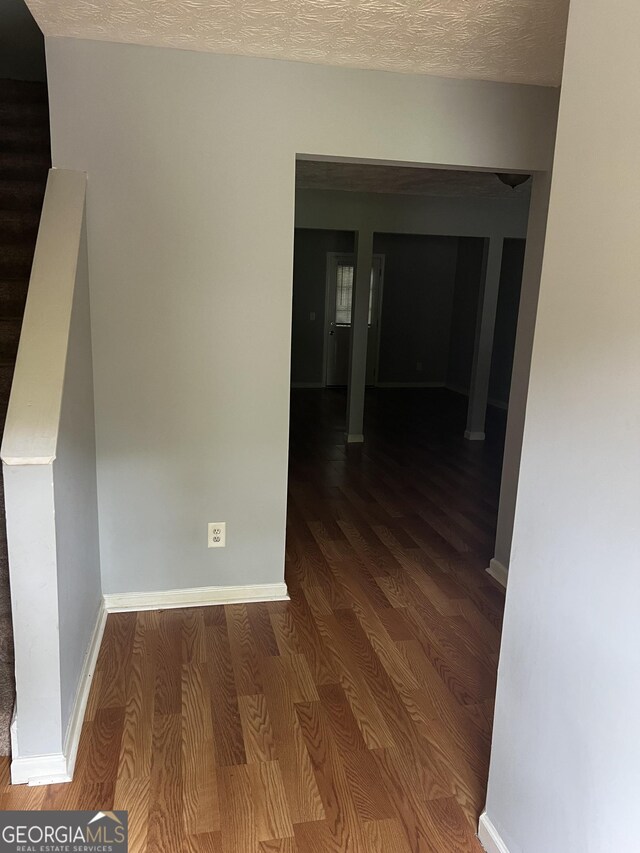 2756 Norfair Loop, Lithonia, GA 30038 - corridor featuring wood finished floors, stairs, and a textured ceiling