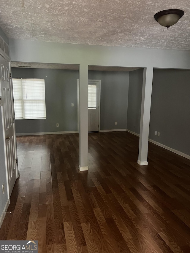 2756 Norfair Loop, Lithonia, GA 30038 - below grade area featuring a textured ceiling, dark wood-type flooring, and plenty of natural light