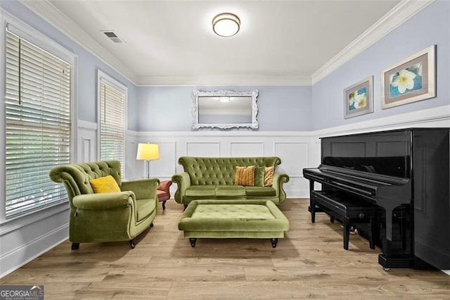 5825 Trailwood Ct, Suwanee, GA 30024 - sitting room featuring ornamental molding, plenty of natural light, wainscoting, wood finished floors, and a decorative wall