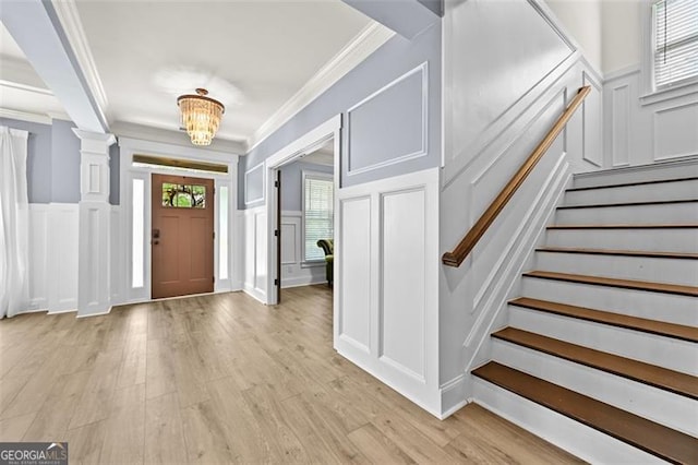 5825 Trailwood Ct, Suwanee, GA 30024 - entrance foyer featuring a decorative wall, crown molding, stairs, light wood-type flooring, and wainscoting