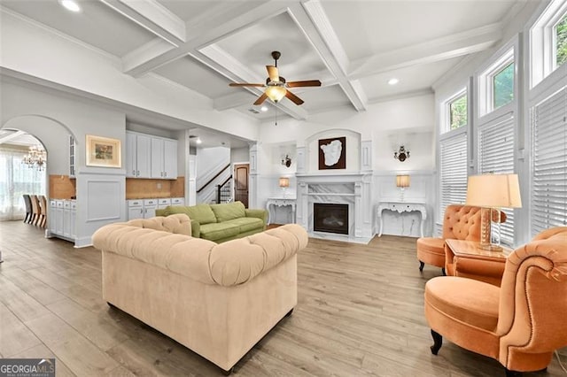 5825 Trailwood Ct, Suwanee, GA 30024 - living area featuring stairway, beamed ceiling, a ceiling fan, light wood-style flooring, and coffered ceiling