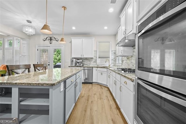 5825 Trailwood Ct, Suwanee, GA 30024 - kitchen with appliances with stainless steel finishes, open shelves, healthy amount of natural light, tasteful backsplash, and recessed lighting